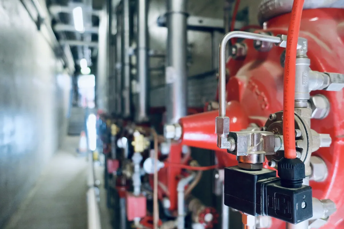 Red fire protection valve and riser assembly inside a plant pump room